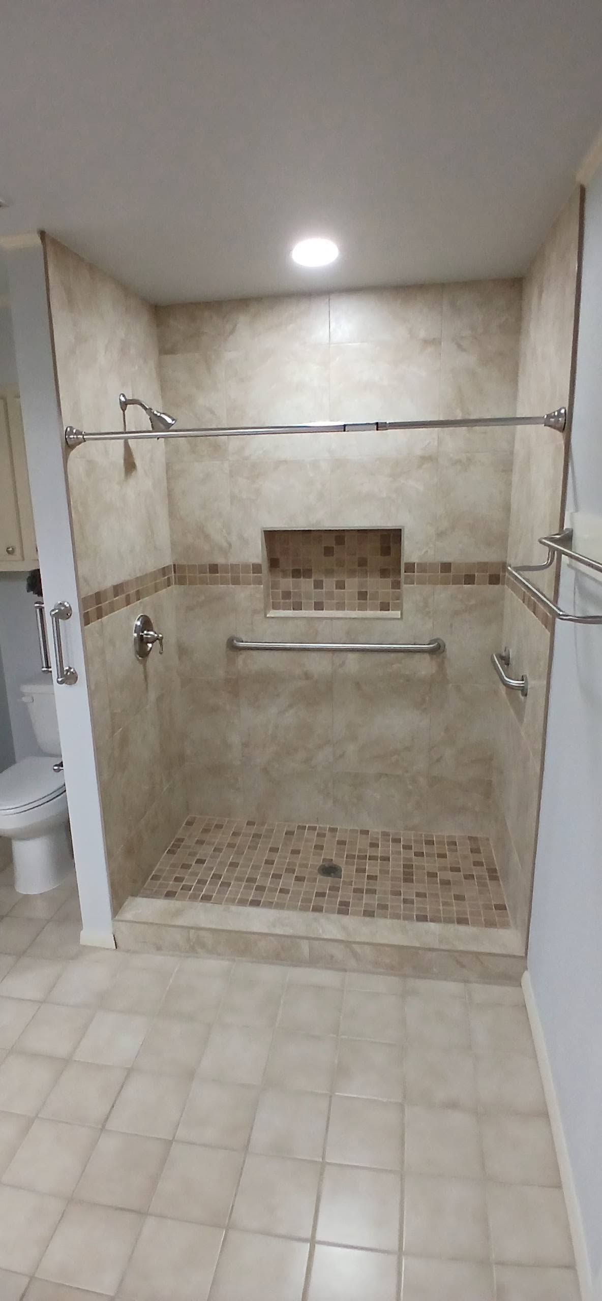Tiled walk-in shower with built-in niche
